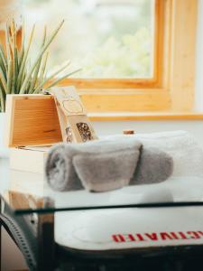 a pile of towels sitting on a table next to a window at Natur Air Suite in Ghiaie +39 photos