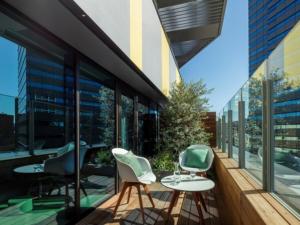 a balcony with chairs and tables on a building at toggle hotel suidobashi - Vacation STAY 06279v in Tokyo