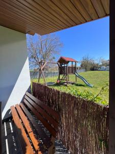 a park with a bench and a playground at Domek na wzgórzu in Ukta