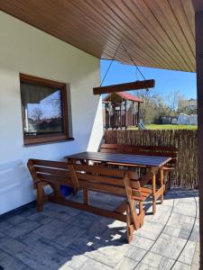 a wooden ping pong table on a patio at Domek na wzgórzu in Ukta +9 photos