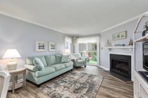 a living room with a couch and a fireplace at 4104 - Sever's Hideaway in Duck