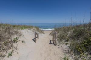 a sandy beach with a wooden path to the ocean at 4104 - Sever's Hideaway in Duck