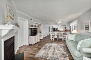 a living room with a couch and a fireplace at 4104 - Sever's Hideaway in Duck