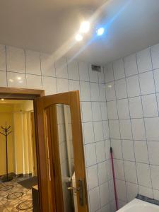a bathroom with a blue light on the ceiling at Central Home in Piatra Neamţ +58 photos