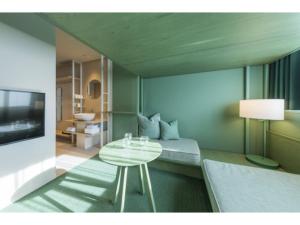 a room with a bed and a table and a television at toggle hotel suidobashi - Vacation STAY 13415v in Tokyo