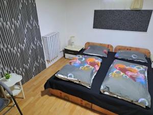 a bedroom with a bed with two pillows with birds on it at Kisfaludy Vendégház in Abádszalók