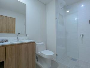 a white bathroom with a toilet and a shower at (Luxury Apartment en Punto Sur in Los Gavilanes +39 photos