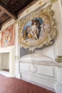 a painting on the wall of a room with a fireplace at Villa Dorigny Dimora Storica con Affreschi e Giardino in Verona