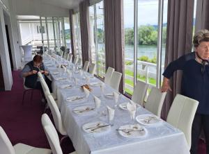 a long table with glasses and plates of food on it at Rooms Đenadija in Hrvatska Kostajnica +19 photos