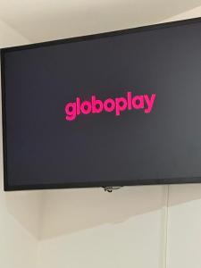 a flat screen television with a pink sign on it at Hospedagem Aconchego in Lagoa Santa +59 photos
