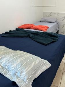 two beds sitting next to each other in a bedroom at Hospedagem Aconchego in Lagoa Santa