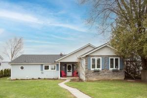 a small house with a porch and a yard at Whispering Swan Bay Haven in Trenton