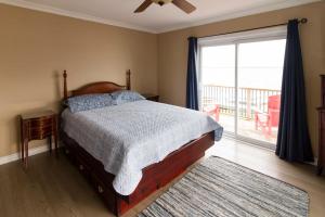 a bedroom with a bed and a large window at Whispering Swan Bay Haven in Trenton