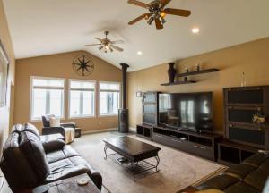 a living room with a couch and a flat screen tv at Whispering Swan Bay Haven in Trenton