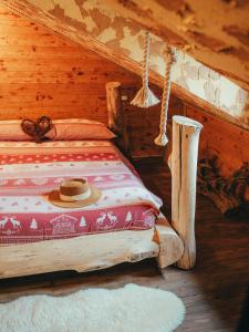 a bedroom with a bed with a hat on it at ALLA STALLA Suite & Chalet in Piazzatorre