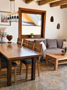 a living room with a table and a couch at Na szlaku Baraniej Góry in Istebna +19 photos