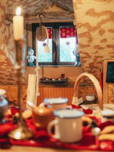 a kitchen with a table with a candle and a sink at ALLA STALLA Suite & Chalet in Piazzatorre