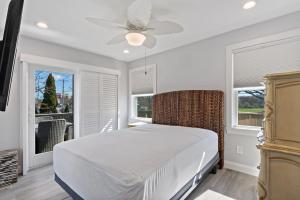 a bedroom with a bed and a ceiling fan at Point Judith Coastal Retreat in Narragansett