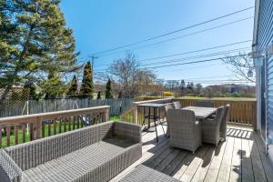 a patio with a table and chairs on a deck at Point Judith Coastal Retreat in Narragansett