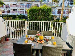 a table with food and orange juice on a balcony at Playa del Cura in Playa del Cura