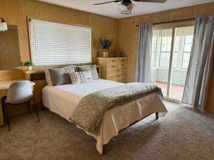 a bedroom with a bed and a desk and a window at Lakeview Lookout in Tool