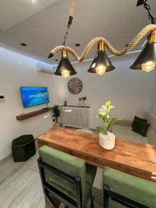 a dining room with a wooden table and three lights at Apartment in Sousse in Sousse