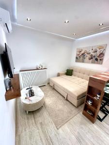 a small living room with a bed and a television at Apartment in Sousse in Sousse