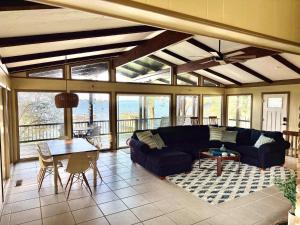 a living room with a couch and a table at Lakeview Lookout in Tool +11 photos