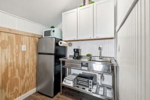 a kitchen with a sink and a refrigerator at Fisher Flats Downstairs in Cedar Key