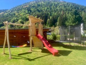 a playground with a slide and a gazebo at Sognatrentino in Cialini