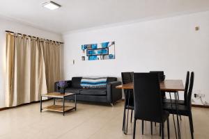 a living room with a couch and a table at JACARANDA - Alojamiento vacacional in Godoy Cruz +11 photos