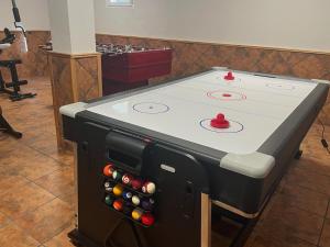 a ping pong table with a bunch of bottles at Las Candelas, Casa Turística in Uruñuela