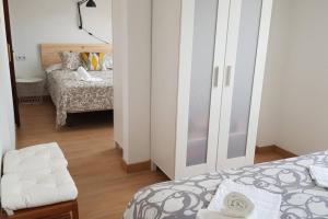 a bedroom with a bed and a room with a bed sqor at La Arena 4410 in Isla +19 photos