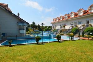 a resort with a swimming pool next to a building at La Arena 4410 in Isla