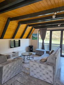a living room with a couch and a table at Villa Sanja I Villa Aleksa in Bratunac