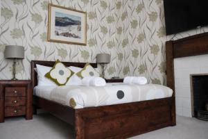 a bedroom with a bed and a fireplace at Gladstone House in Edinburgh