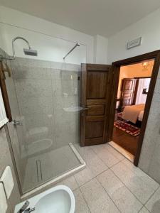 a bathroom with a glass shower and a sink at Boutique Hotel Vila Aleksander in Berat +56 photos