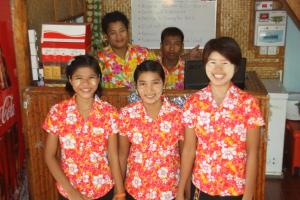 a group of people in floral shirts posing for a picture at Soe Ko Ko Beach House & Restaurant in Ngwesaung