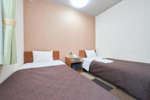 Postel nebo postele na pokoji v ubytování Hotel Select Inn Utsunomiya