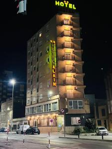 a hotel building with a hotel sign at night at Hotel Alain by Dynamic Hotels in Silla