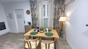 a dining room with a wooden table and chairs at Villamadrid Home 2 in Madrid