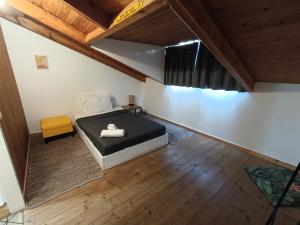 a bedroom with a bed in a room with wooden floors at Bougainvillea Apartment Spacious Family Home in Zakynthos Town in Zakynthos