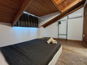 a bedroom with a large bed in a room with wooden ceilings at Bougainvillea Apartment Spacious Family Home in Zakynthos Town in Zakynthos
