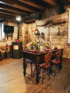 a dining room with a table and a stove at ALLA STALLA Suite & Chalet in Piazzatorre