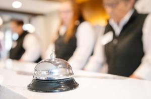 a bell on a table with people in the background at The Highlands at Harbor Springs in Harbor Springs