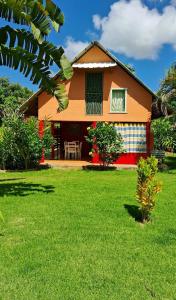 a house with a green lawn in front of it at Labellaventura in Las Galeras