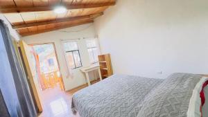 a bedroom with a bed in a room with windows at Luminous Haven Atitlan #1 in San Marcos La Laguna