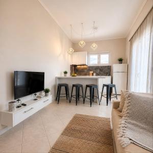 a living room with a couch and a kitchen at Villa Joanna in Vasilikos