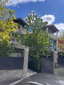 a house with a blue gate in front of it at URBAN House Vienna in Gerasdorf bei Wien