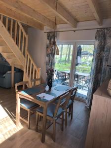 a dining room with a table and some chairs at Mia Domo - wypoczynek w Górach Suchych, Kamiennych i Sowich in Głuszyca